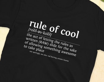 Könnte beinhalten: Schwarzes T-Shirt mit weißem Text, der "rule of cool /rool-ev-kool/ the act of letting the rules as written (RAW) slide for the sake of allowing something awesome to take place use sparingly see also rad herring artistic license" lautet.