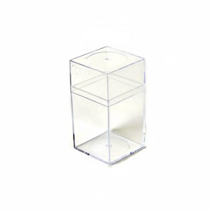 May include: A clear, rectangular plastic display box with a removable lid. The container features a transparent, rigid structure with a square base and a matching square top cover, providing a simple and functional enclosure for small items.