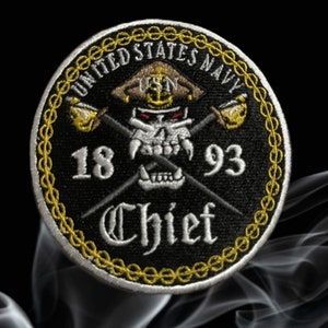 May include: Embroidered patch featuring a skull wearing a naval hat, crossed swords, and the text "UNITED STATES NAVY" and "Chief". The patch is black with gold and white accents, and the years "1893" and "1893" are also displayed.