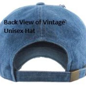 May include: Back view of a blue denim unisex hat with a curved brim and adjustable strap. The hat features the text "Back View of Vintage Unisex Hat". The strap has a brass-colored metal buckle.