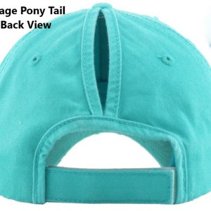 May include: A turquoise baseball cap with a ponytail opening at the back. The cap has a curved brim and an adjustable strap. The text "Vintage Pony Tail Hat-Back View" is printed on the top left of the image.