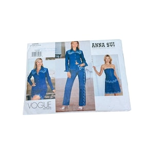 May include: A Vogue Patterns sewing pattern envelope for Anna Sui designs, featuring images of a denim jacket, skirt, pants, and strapless dress with scalloped white trim. The envelope displays the number 2666 and the Vogue Patterns logo.