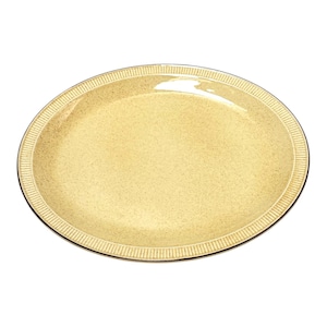 May include: A round, light yellow ceramic plate with a speckled finish and a textured, ribbed border along the outer edge. The surface has a glossy sheen, and the rim features a series of vertical, parallel lines encircling the entire plate.