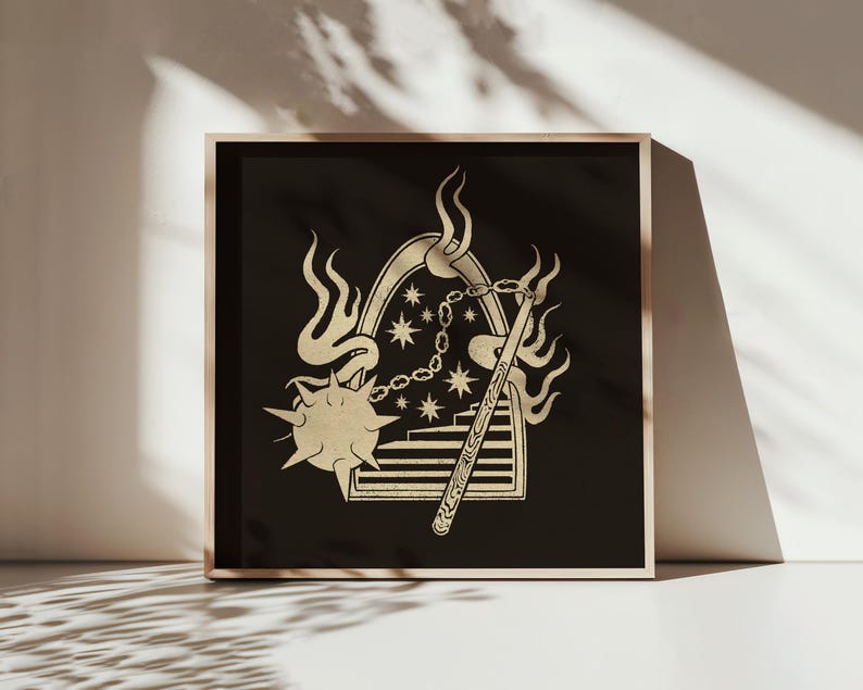 May include: A framed art print featuring a gold-colored illustration on a black background. The design includes a mace, flames, stars, and a staircase. The artwork is displayed in a light-colored wooden frame, creating a striking contrast.