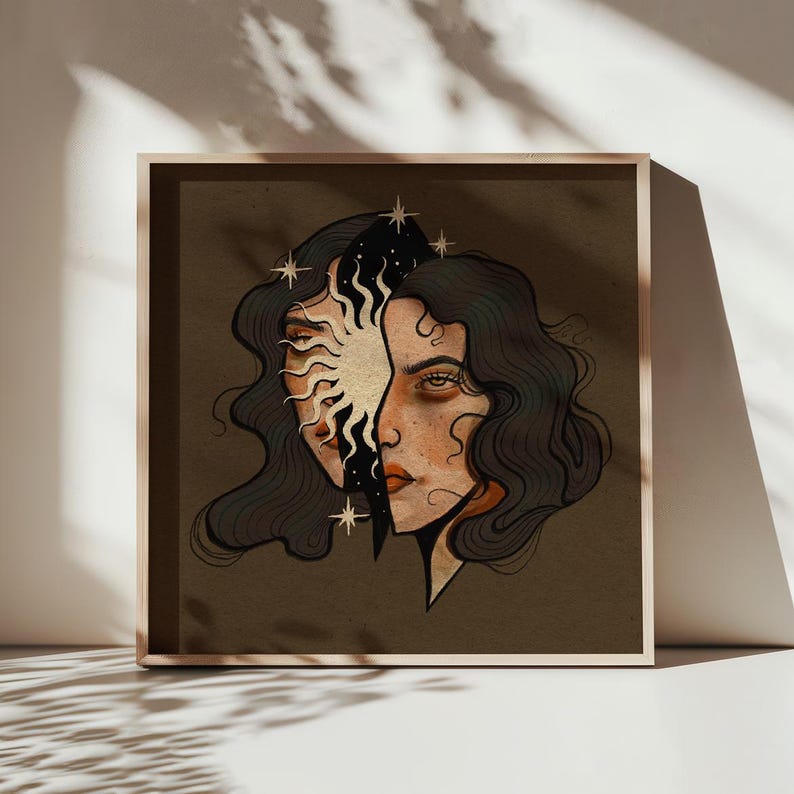 May include: Framed art print with a split face design. One side shows a sun, the other a woman's face. The artwork uses gold, black, and brown tones, with star accents and wavy hair, creating a striking visual.