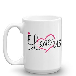 May include: White ceramic mug with the words "I Love Us" in black and pink script. The word "Love" is written inside a pink heart. A small pink heart is above the letter "I".