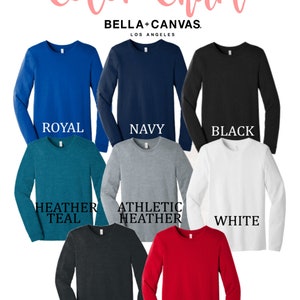 May include: Color chart showing different long-sleeve t-shirt colors from Bella + Canvas. The colors are: Royal, Navy, Black, Heather Teal, Athletic Heather, White, Dark Heather, and Red.