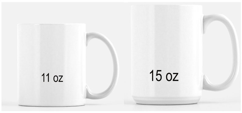 May include: Two white ceramic mugs with curved handles. The smaller mug is labeled "11 oz", and the larger mug is labeled "15 oz". Both mugs are empty and have a glossy finish. The mugs are designed for beverages.