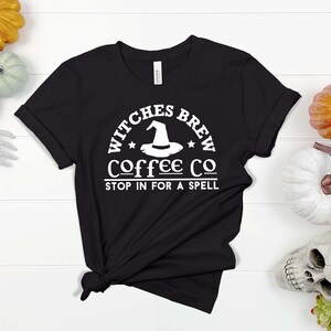 May include: Black t-shirt with a white graphic that says "Witches Brew Coffee Co. Stop in for a spell". The graphic includes a witch's hat.