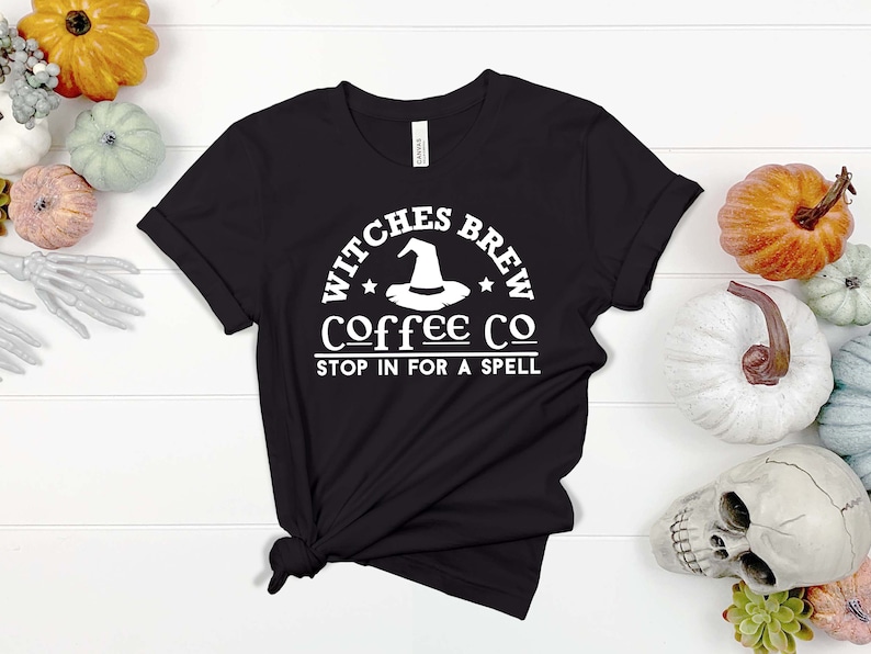 May include: Black t-shirt with a white graphic that says "Witches Brew Coffee Co. Stop in for a spell". The graphic includes a witch's hat.