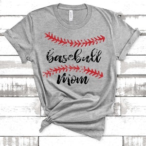 May include: Gray t-shirt with the text "baseball mom" in black lettering and red baseball stitching above and below the text.