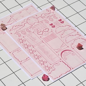 May include: Two pink character sheets with celestial and fantasy-themed illustrations, including moons, stars, and clouds. The sheets have various sections for stats and notes, with a few red dice scattered around. The sheets are on a white grid surface.