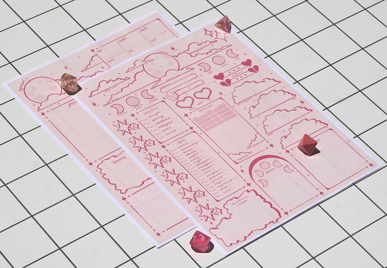 May include: Two pink character sheets with celestial and fantasy-themed illustrations, including moons, stars, and clouds. The sheets have various sections for stats and notes, with a few red dice scattered around. The sheets are on a white grid surface.
