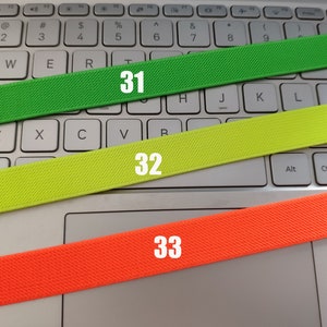 May include: Three elastic bands of different colors: green, yellow, and orange. The bands are labeled with the numbers 31, 32, and 33.