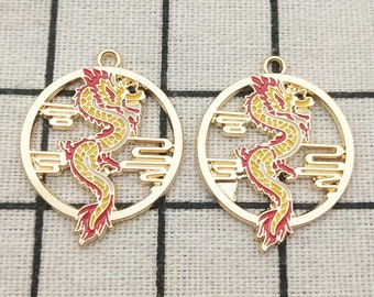 May include: Two gold-colored metal charms featuring a red and yellow dragon design. The dragon is depicted in a circular frame with a cloud pattern.