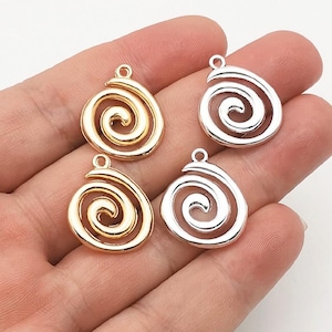 May include: Four metal charms in a spiral shape, featuring two gold-toned pieces and two silver-toned pieces. Each charm has a small circular loop at the top for attachment, with a smooth, polished finish and a continuous swirling design.