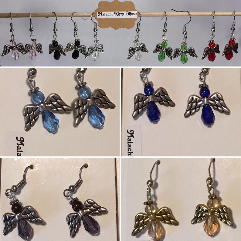 May include: A set of angel wing earrings featuring a variety of coloured crystal beads. The earrings are silver-toned and have a delicate design. The crystals are in shades of pink, black, clear, green, blue, red, purple, and gold.