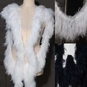 May include: White and black feather trim, shown on a dress form and as a close-up. The trim is soft and fluffy, and would be great for adding a touch of elegance to any project.