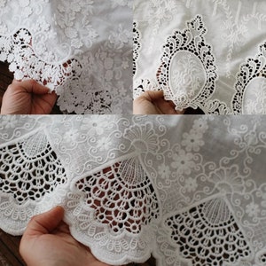 May include: White cotton fabric with delicate lace trim. The lace features a floral design with intricate details. The fabric is soft and airy, perfect for a summer dress or blouse.