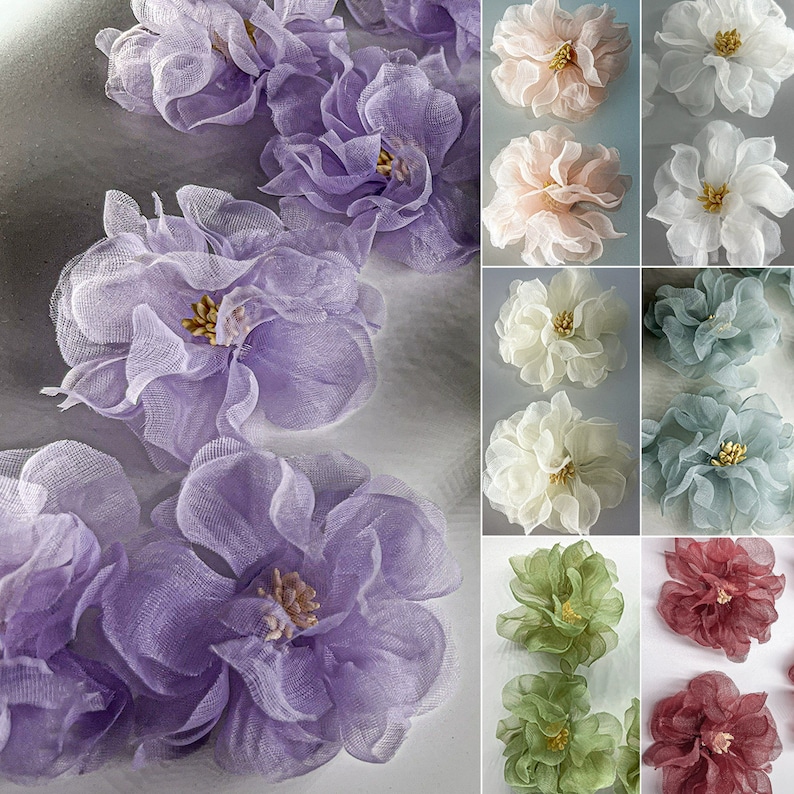 May include: A collection of 10 delicate, layered, sheer fabric flowers in various colors, including white, cream, light blue, lavender, green, and pink. The flowers are arranged in a grid pattern, with each flower having a slightly different shape and size.