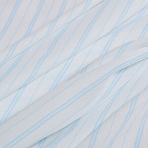 May include: White fabric with light blue diagonal stripes. The fabric has a soft, flowing texture.