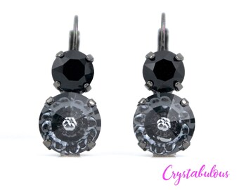 May include: A pair of dangle earrings with two black and gray crystal stones. The earrings have a silver hook closure.