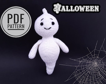 Könnte beinhalten: Ein weißes gehäkeltes Geister-Amigurumi-Spielzeug mit schwarzen Augen und einem lächelnden Mund. Das Spielzeug steht auf einem schwarzen Hintergrund mit einem weißen Spinnennetz in der Ecke. Der Text "PDF PATTERN" befindet sich in einem Kreis auf der linken Seite des Bildes. Der Text "HALLOWEEN" befindet sich oben im Bild.