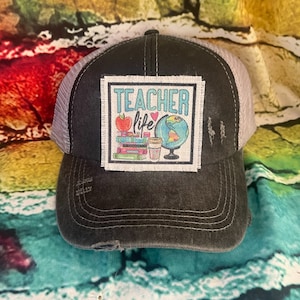 May include: A white ceramic mug with a black handle and the text "But First, Coffee" in a black, bold font. The mug is on a white surface. The mug is approximately 4 inches tall.