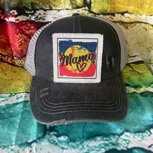 May include: Black and gray distressed baseball cap with a white patch featuring a colorful baseball with the word "Mama" and a heart.