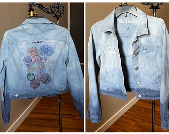 Over-dyed jean jacket with hand embroidered back panel.