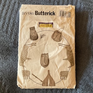 May include: A vintage sewing pattern for making various bags and pouches. The pattern is titled "B5580 Butterick" and features a drawing of different bag styles.