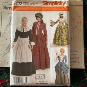May include: Simplicity sewing pattern number 3723 for a colonial era dress. The pattern includes three different dress styles, one with a white apron, one with a floral print, and one with a blue and brown print. The pattern is for sizes 14, 16, 18, 20, and 22. The pattern is available in European sizes 40-48 and French sizes 42-50.