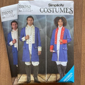 May include: Two Simplicity costume sewing pattern envelopes. The patterns are for historical costumes, featuring blue coats with white and red accents. The envelopes display images of the costumes on models, with the pattern number S9252 visible.