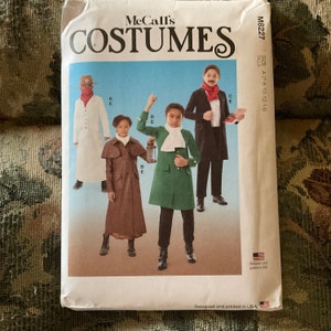 May include: McCall's Costumes sewing pattern for children's costumes. The pattern includes four different costumes: a white colonial gentleman, a brown colonial gentleman, a green colonial gentleman, and a black colonial gentleman. The pattern is for sizes 7-8, 10-12, and 14.