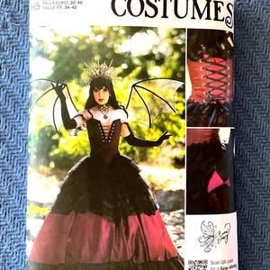 May include: Simplicity Costumes sewing pattern R12203. The package features a woman in a black and red gothic costume with bat wings. The pattern includes sizes US 6-14 and European sizes 32-40.