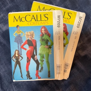 May include: Three McCall's Costumes sewing patterns. The patterns feature illustrations of various costumes, including a Harley Quinn-inspired outfit, a Catwoman-inspired costume, and a Poison Ivy-inspired costume. The patterns are labeled M7269 and include size information.