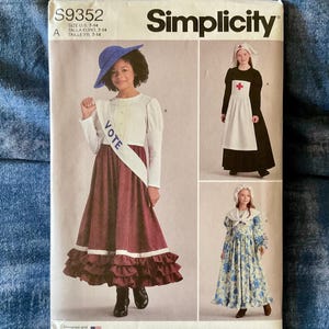 May include: Simplicity sewing pattern S9352 for children's costumes in sizes 7-14. The envelope features illustrations of three historical outfits: a suffragette with a blue hat and VOTE sash, a nurse with a white apron, and a floral print dress.