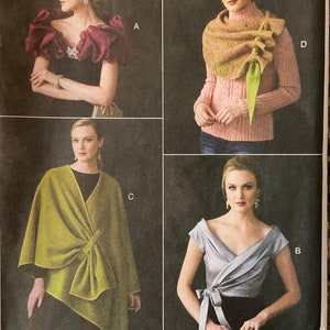 May include: Four different ways to style a scarf or shawl. The first image shows a woman wearing a burgundy shawl with ruffles. The second image shows a woman wearing a light pink sweater with a green scarf. The third image shows a woman wearing a green shawl. The fourth image shows a woman wearing a silver top with a black sash.