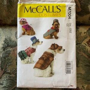 May include: A sewing pattern for dog costumes, featuring four different designs: a detective, a pirate, a steampunk, and a Victorian. The pattern is for size OSZ and is from McCall's Costumes.