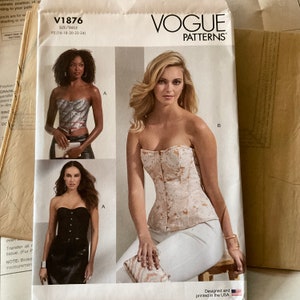 May include: Vogue Patterns sewing pattern for a strapless corset, with a white background and the text "V1876" and "Vogue Patterns" printed on it.