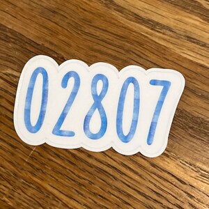 May include: A blue and white sticker with the number 02807.