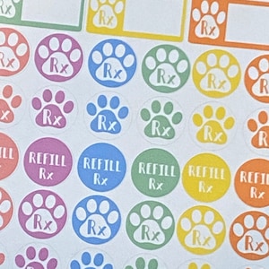 May include: A sheet of colorful paw print stickers with the text "Rx" and "Refill Rx" on some of the stickers.