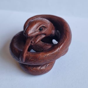 Vintage finely detailed hand-carved boxwood coiled snake netsuke intricate design,representing rebirth and fortune .signed to base