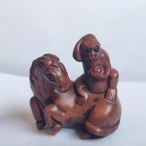 Vintage finely detailed hand-carved boxwood netsuke  Japanese monkey on a horse signed on base