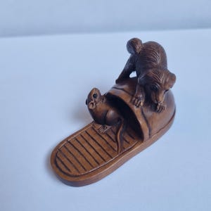 Vintage finely detailed hand-carved boxwood rat and puppy sitting on a sandal netsuke intricate design  ,representing wealth.signed to base