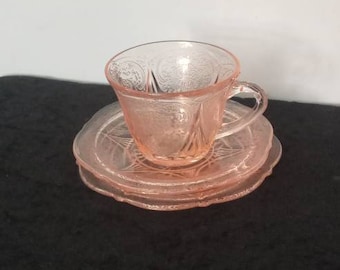A delightful trio of 1930s Hazel Atlas American Depression era glass pink Royal Lace includes a tea cup,saucer and side plate