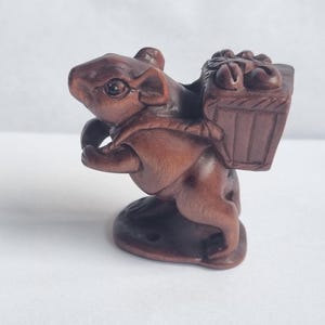 Vintage finely detailed hand-carved boxwood mouse carrying harvest netsuke intricate design representing harvest and wealth.signed to base