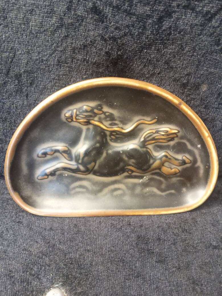 Scarce and decorative Knud Khyn Royal Copenhagen Pottery brown tray with a galloping horse.