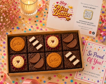 May include: A rectangular cardboard box containing eight square chocolate brownies topped with various cookies and chocolate pieces. The box is accompanied by a white card with the text Hey Miss Butter and a QR code, and a card reading So Proud of You.