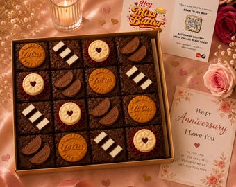 May include: A square gift box containing sixteen chocolate brownies topped with Lotus Biscoff cookies, white chocolate striped bars, and heart-centered biscuits. Includes a card with the text Hey Miss Butter and an anniversary greeting card.